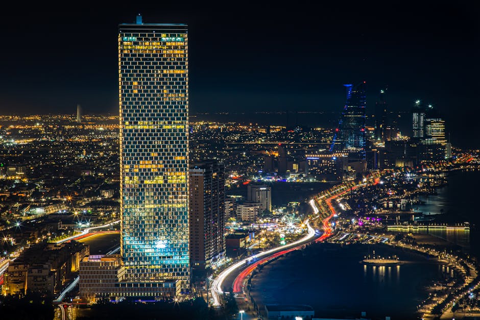 pexels photo 12694176 12694176 Capture the essence of Jeddah's vibrant cityscape with glowing skyscrapers and bustling streets at night.